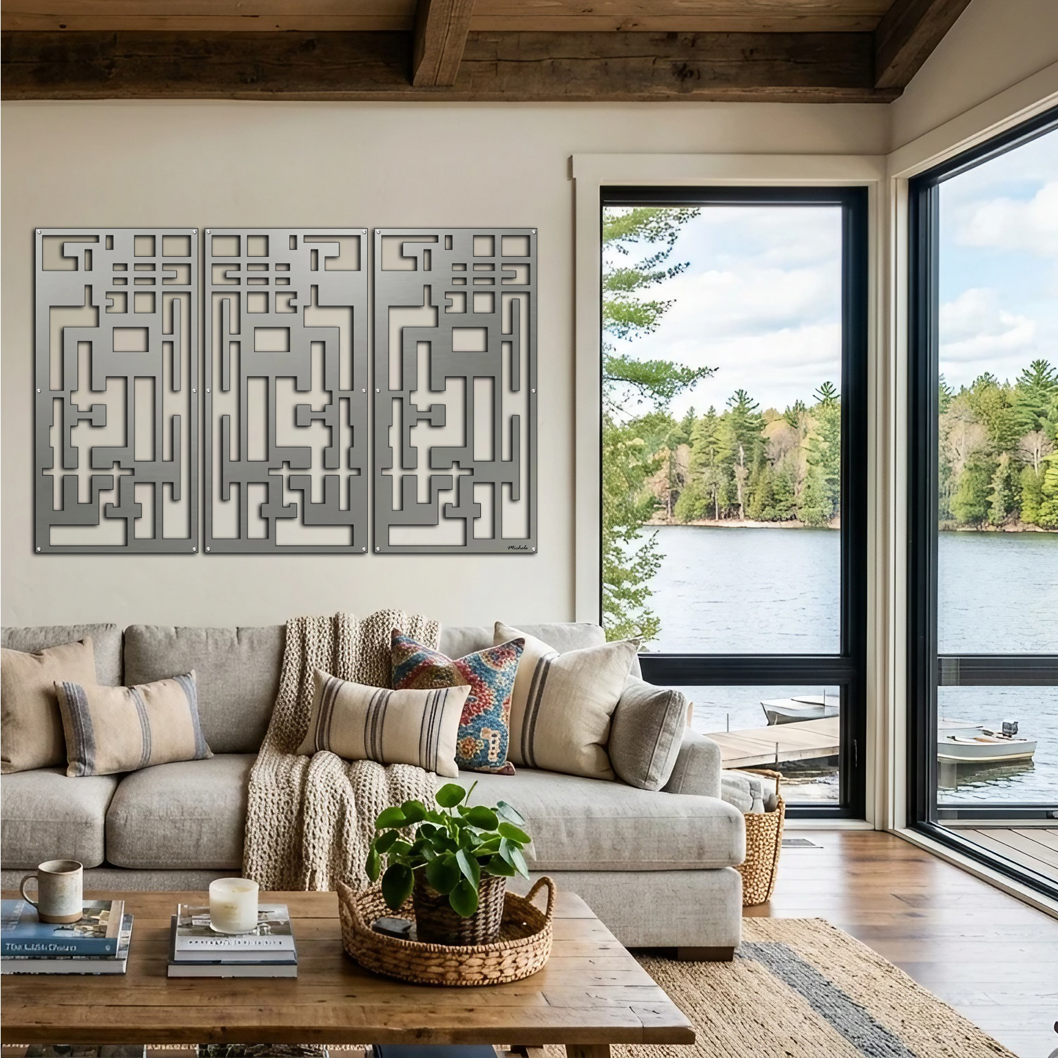 Modern living room features three abstract wall art pieces, a cozy sofa, and large windows overlooking a lake.