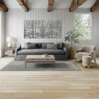 Modern living room with a gray sofa, coffee table, decorative wall art, and a plant by the window.