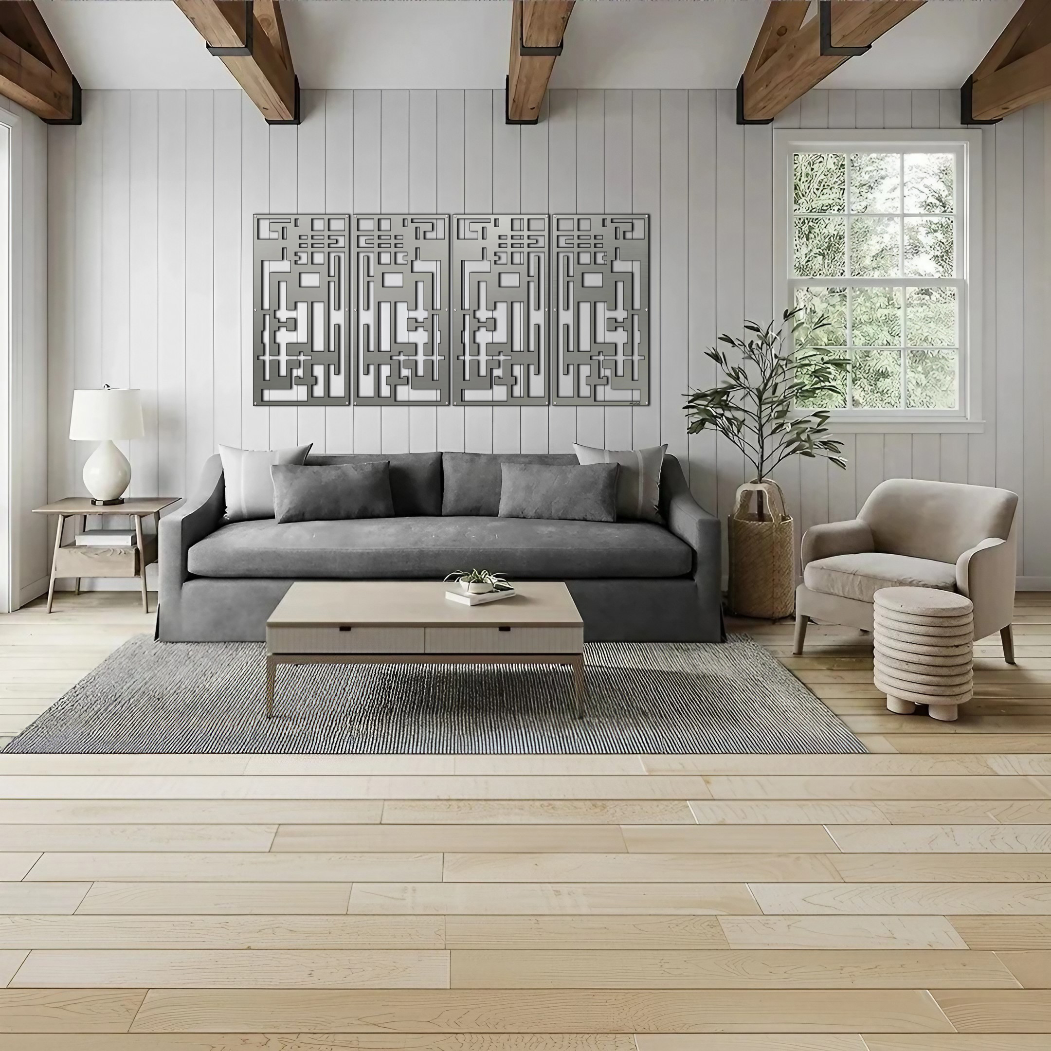 Modern living room with a gray sofa, coffee table, decorative wall art, and a plant by the window.