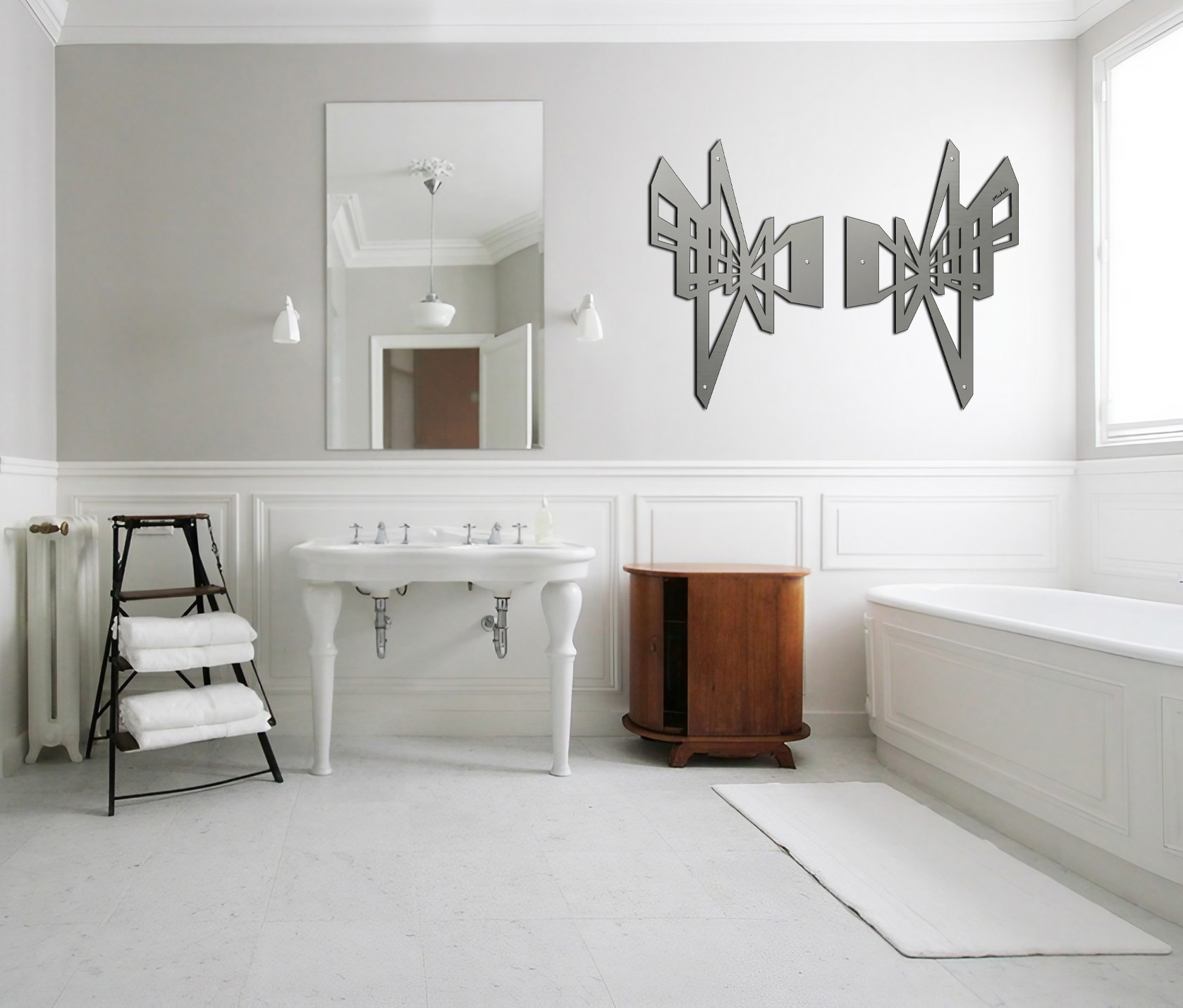 Modern bathroom featuring a freestanding sink, wooden cabinet, and decorative wall art. White towels on a rack.