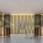Modern lobby with a marble reception desk and decorative wall featuring a geometric design and ambient lighting.