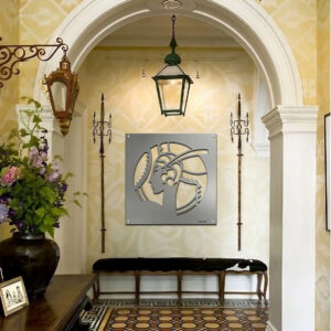 A hallway features a metal art piece of a woman's profile, floral arrangement, and decorative lanterns.