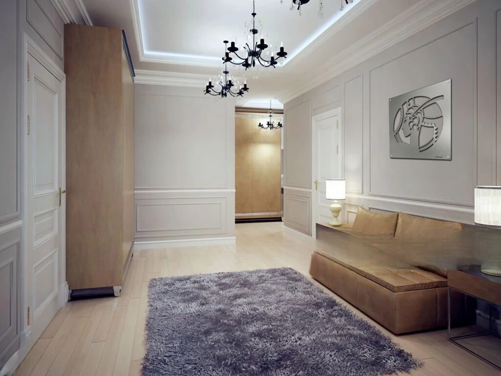 A modern hallway features a plush rug, sleek sofa, wall art, and elegant lighting fixtures.