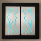 Two illuminated panels feature abstract silhouettes of nude figures, outlined in blue against a metallic background.