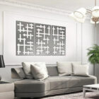 Modern living room features a gray sofa with pillows, decorative wall art, and a potted plant.