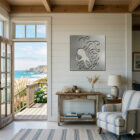 A coastal living room features an octopus metal art piece on the wall, with ocean views through the open door.