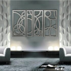 Modern living room features gray walls, circular decor, and a four-panel abstract wall art piece. Two gray sofas face each other.