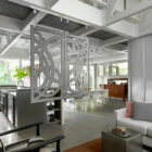 Modern living room featuring a decorative sliding partition, kitchen area, and stylish furniture.