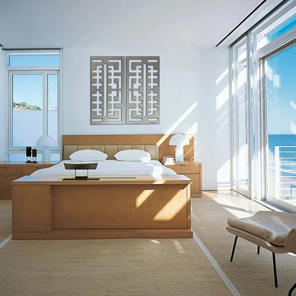 Bright, modern bedroom with a large bed, decorative wall art, and ocean view through glass doors.