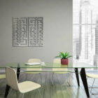 Modern office meeting space with a glass table, four chairs, a potted plant, and abstract wall art. City skyline visible through windows.