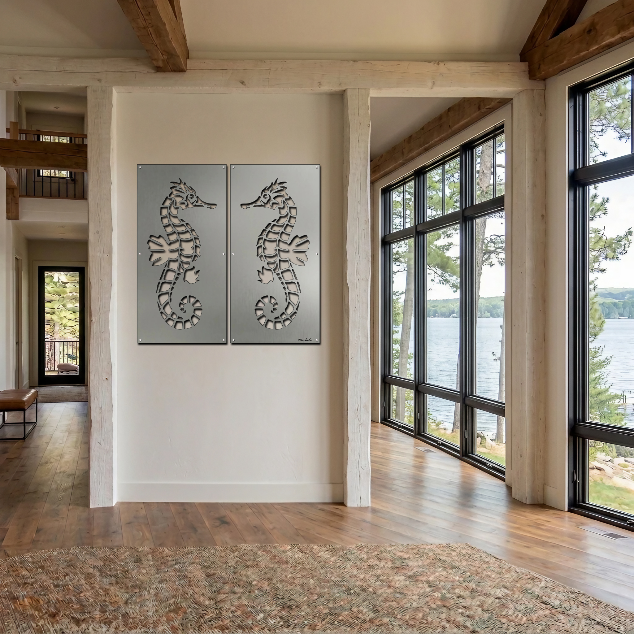 Two metal seahorse artworks hang on a white wall in a bright, modern room with large windows overlooking a lake.