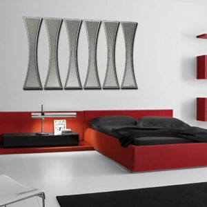 Modern bedroom featuring a red bed, black bedding, a sleek lamp, and a unique wall art piece.