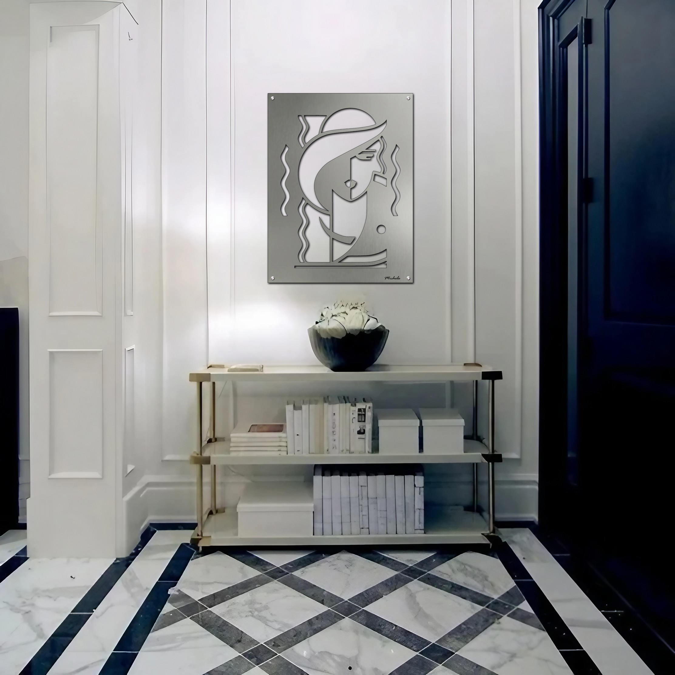 A modern hallway features a metal artwork, a vase with flowers, and a shelf with books.