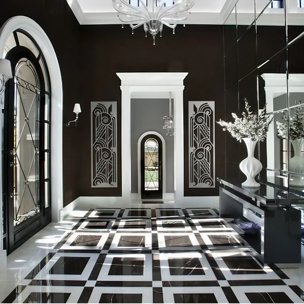 Elegant foyer with black and white checkered floor, decorative wall panels, and a large vase of flowers.