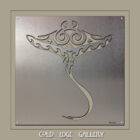 Stylized manta ray design on a metallic background, featuring intricate patterns and smooth lines.