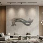 Modern living room features a large abstract wall sculpture, minimalist furniture, and large windows.