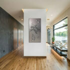 Metal wall art of a sea turtle and fish, displayed in a modern interior space with wooden flooring.