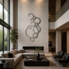 Modern living room features a large abstract metal wall art, sectional sofa, and a sleek coffee table.