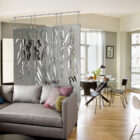 A living room features a decorative curtain with weeping willow designs, a gray sofa, and a dining area.