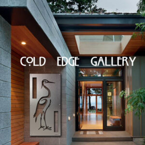 Modern entrance featuring large metallic crane artwork, labeled "Cold Edge Gallery," with glass doors, wooden accents, and greenery visible in the background.