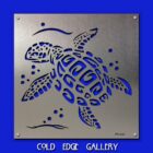 Metal artwork of a turtle with swirling patterns, set against a blue background. Text at the bottom reads "COLD EDGE GALLERY.
