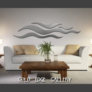 A minimalist living room featuring a white sofa, wooden coffee table, two side tables with lamps, and wave-like wall art. Text at the bottom reads "COLD EDGE GALLERY.