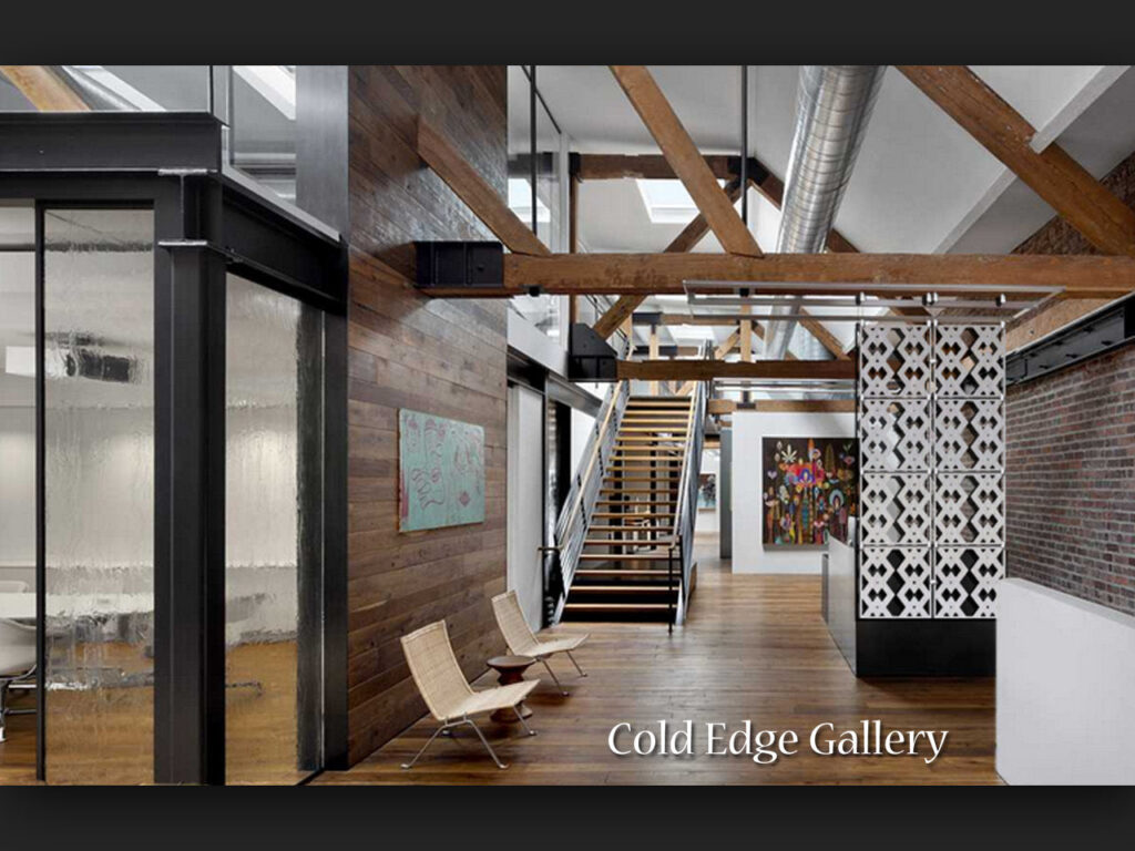 Interior of Cold Edge Gallery featuring wooden beams, artwork, and modern seating. Stairs lead to an upper level.