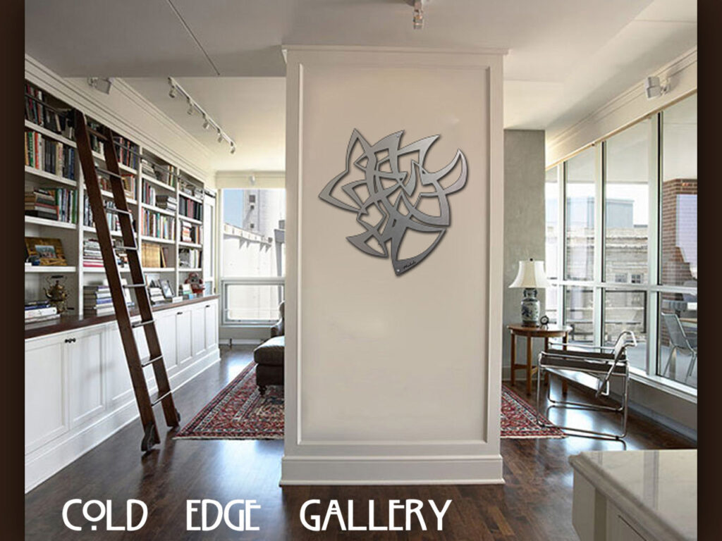 Modern art piece displayed on a white wall in a stylish room with bookshelves and a ladder.