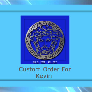 A blue framed graphic depicting a custom order for Kevin from Cold Edge Gallery, featuring a metal medallion design with a Greek-inspired face.
