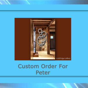 Framed interior photo showcasing custom metal artwork in a wood-finished hallway. Text: "Custom Order For Peter" and "Cold Edge Gallery" at the bottom.