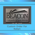 A custom metal plaque for "Beacon Orthopaedics & Sports Medicine," crafted as a unique artwork by Cold Edge Gallery, designated for "Robyn".