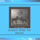 A metal art piece featuring two deer with antlers facing each other under a full moon. The text reads "Cold Edge Gallery" and "Custom Order For Steven.