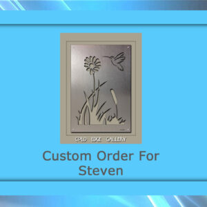 A custom metal wall panel featuring an intricate floral and bird design is displayed. The text "Custom Order For Steven" appears beneath the stunning artwork, which is bordered by a blue frame.