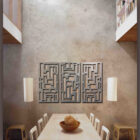 Geometric metal artwork with custom rectangular and square cut-outs is displayed on a light beige background. The sign on the right reads "COLD EDGE GALLERY.