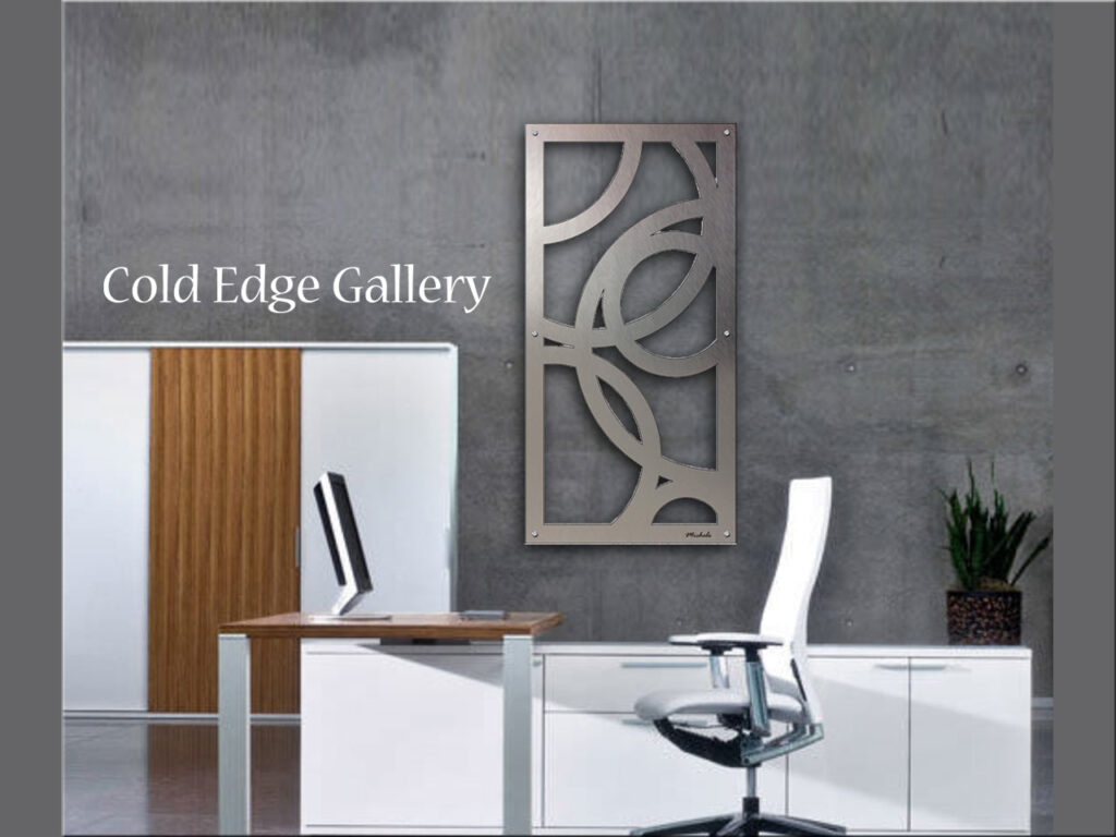 Modern office space features a decorative metal wall art piece and a sleek desk with a chair.