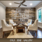 A modern, indoor seating area with four beige chairs, a small wooden coffee table, and geometric wall art on wood-paneled wall. The room has a ceiling fan and large windows. Text "COLD EDGE GALLERY".
