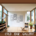 A modern gallery room with wooden floors and large windows features abstract wall art and a few pieces of furniture, including a chair. A cat is walking on the floor. The text reads "Cold Edge Gallery.