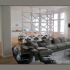 Modern living room with grey sectional sofa, lounge chair, and coffee table. Room divider with circular pattern separates living area from dining space and kitchen. Text reads "Cold Edge Gallery.