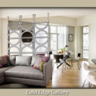 Modern living room with a grey sectional sofa, colorful pillows, and a decorative metal room divider. Dining area with a round table and chairs in the background. "Cold Edge Gallery" text at the bottom.