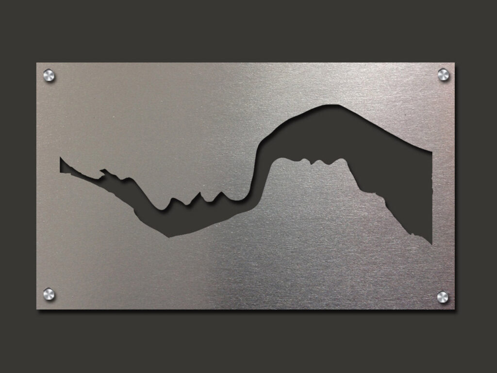 Metal panel featuring a cutout silhouette of a mountain range against a brushed silver background.