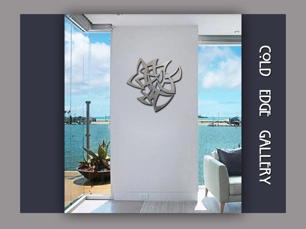 A modern art piece hangs on a white wall, with a view of water and plants visible through large windows.