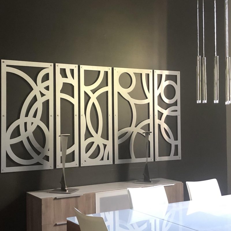Modern dining area featuring abstract wall art, candle holders, and a wine rack.