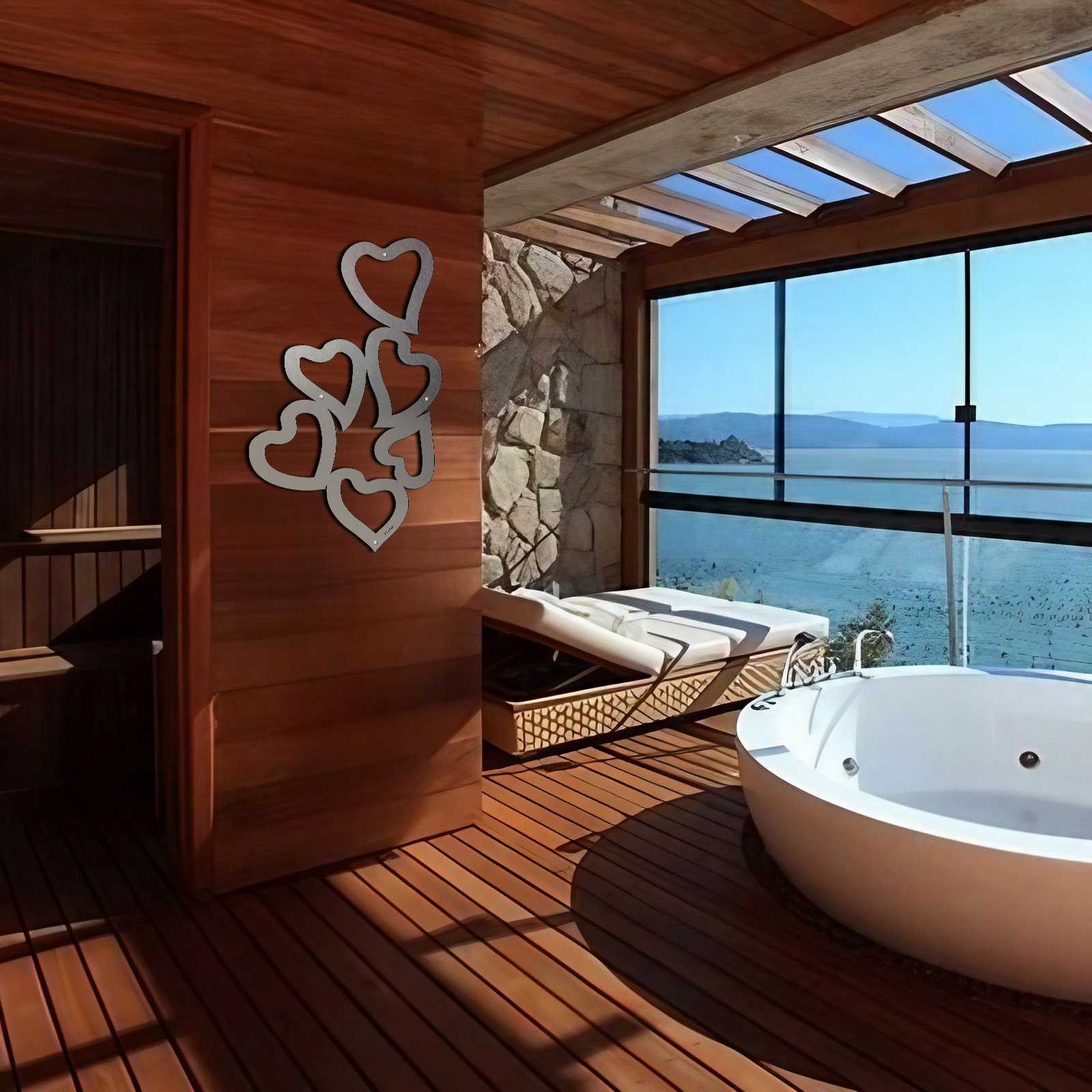 A modern bathroom features a heart-shaped wall decoration, a bathtub, and a view of the water through large windows.