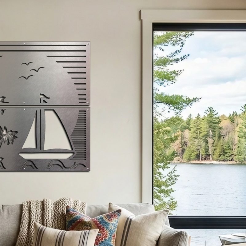 Metal wall art depicting a sailboat and palm trees, with a lake and forest view through large windows.