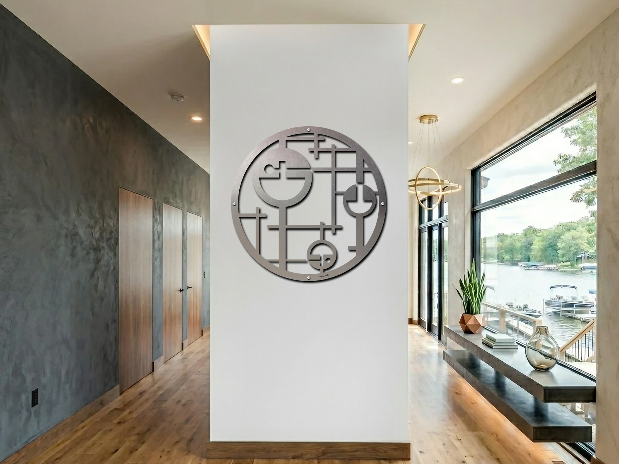 Abstract metal circle artwork hangs on a white wall in a modern lake house interior.