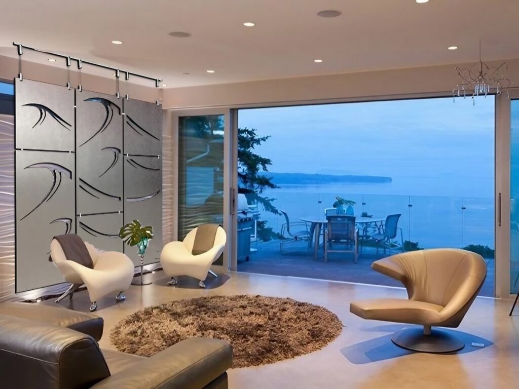Modern living room with a wave-patterned room divider, stylish chairs, and a view of the ocean.
