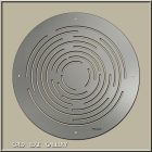 Circular metal maze design with concentric lines, displayed in a gallery setting.